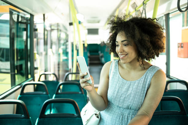 istock Smiling african woman talking on phone in bus 1062745150