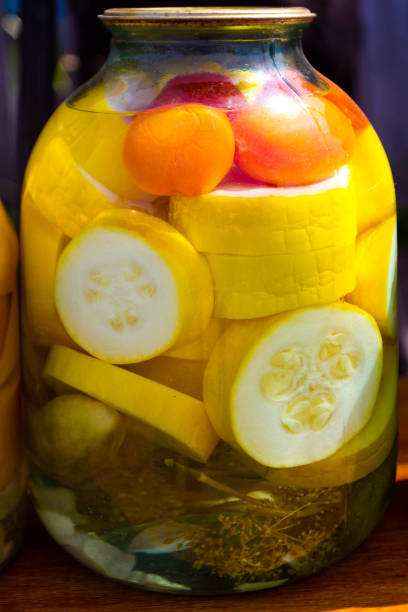 istock Yellow zucchini and red tomatoes marinated in a glass jar 1062747752