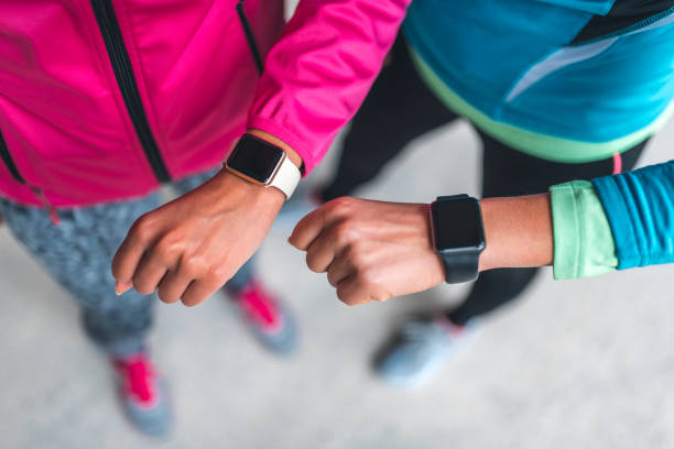 istock Young sportswomen comparing training results on smart watch 1062750796