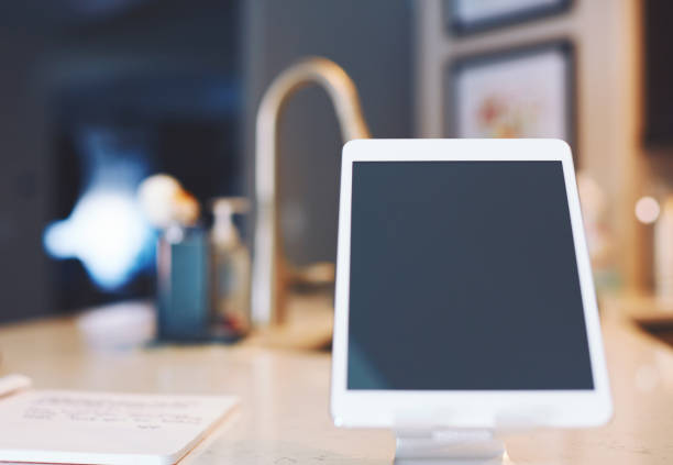 Digital tablet on stand in domestic kitchen