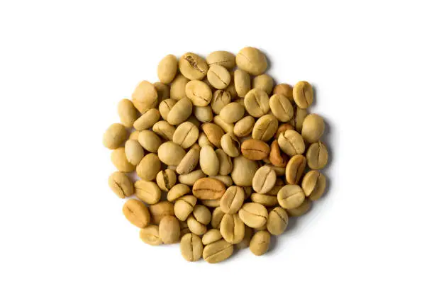 Fresh arabica coffee bean seeds on a white background.