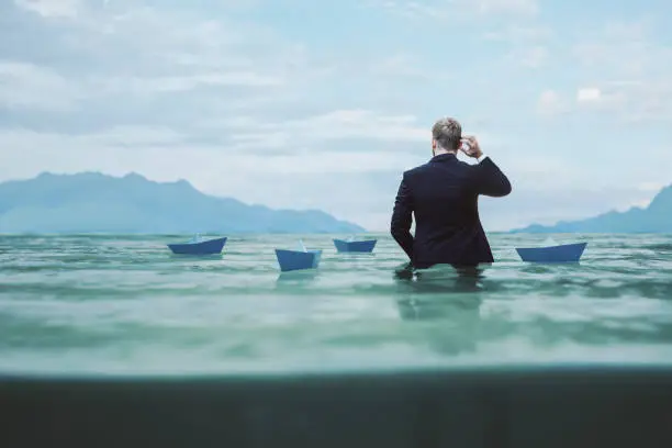 Lost and confused businessman in water.