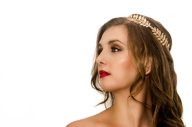 Close-up portrait of beautiful Russian woman wearing national accessories decorated with flowers and berries.