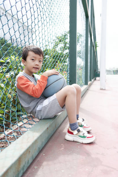 istock Cute little boy playing basketball 1062782708