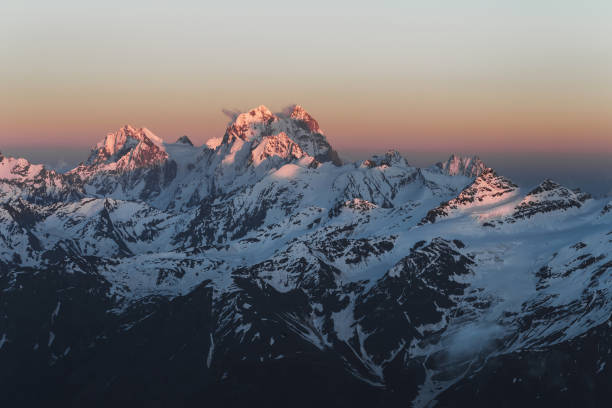 istock Panoramic view on Ushba peak at sunset from Elbrus. Mountain range view 1062784412