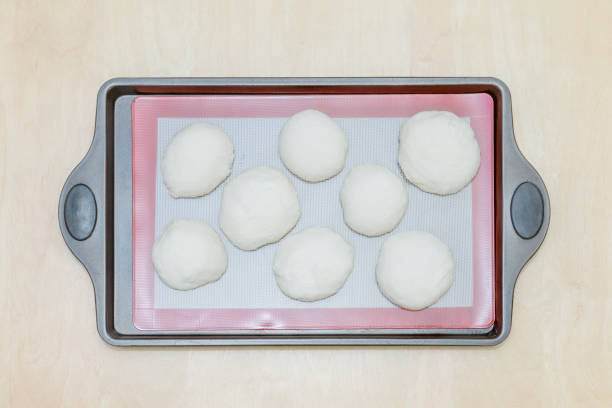 istock balls of dough on a silicone baking mat, on an iron tray 1062793752