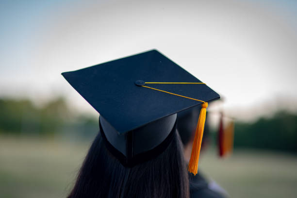 istock Back portrait of graduated wearing a black hat. 1062799120