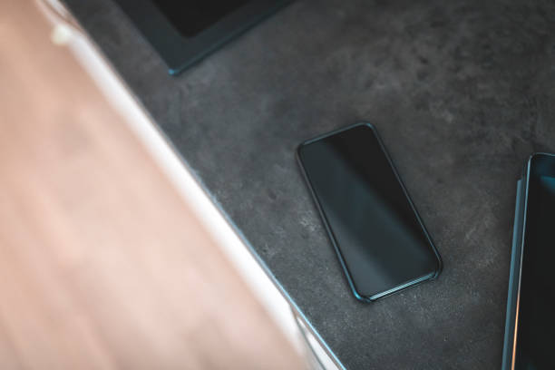 istock Mobile phone on kitchen counter in modern apartment. 1062809216