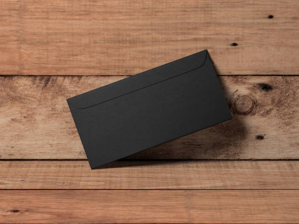 istock Black paper envelope mockup on wooden background 1062811310