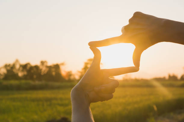 istock Hands making frame with sunset. Close up of woman hands making frame gesture. 1062826312
