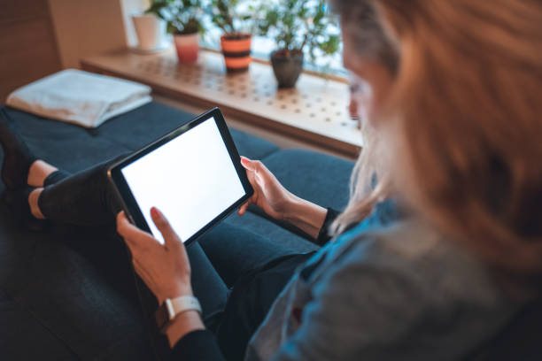 istock Young woman using digital tablet at home 1062826620