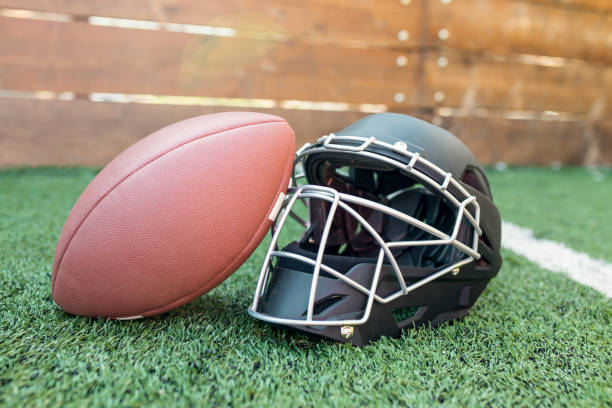 istock Rugby helmet with ball on green grass 1062829488