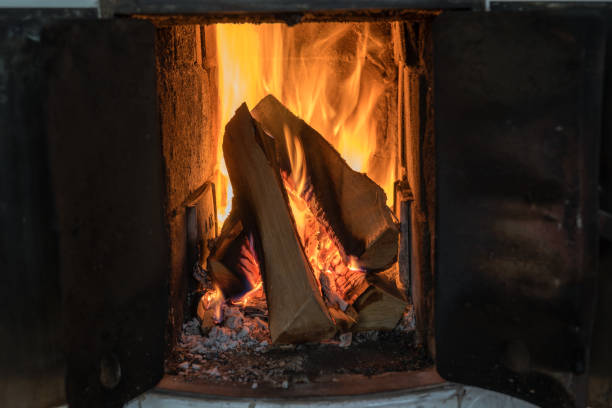 istock fire in a tiled stove with white tiles 1062829538
