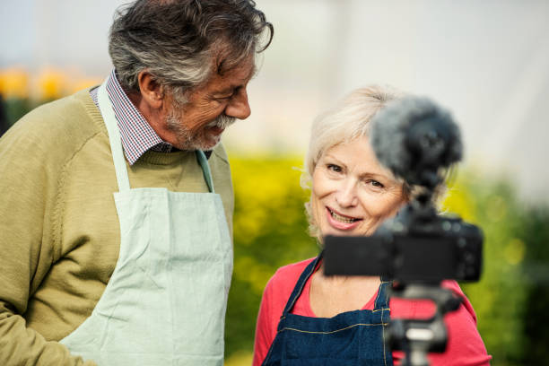 istock Senior couple vlogging in greehouse 1062830980