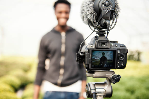 istock Young man vlogging in greehouse 1062831084
