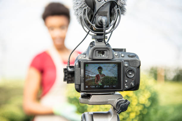istock Young woman vlogging in greehouse 1062831086