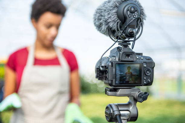 istock Young woman vlogging in greehouse 1062831088