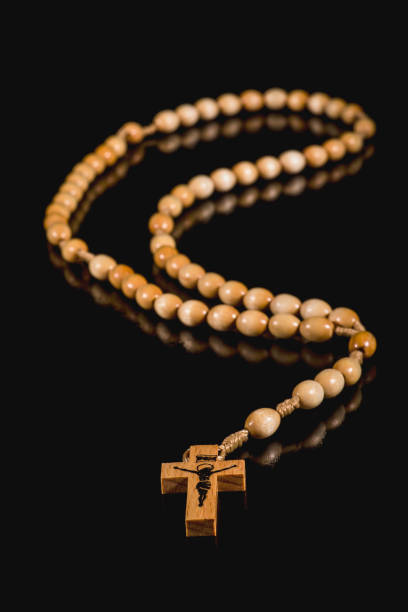 istock A brown rosary lying on a black background 1062831540
