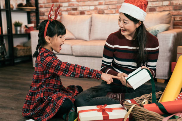 istock family wrapping the christmas present. 1062831648