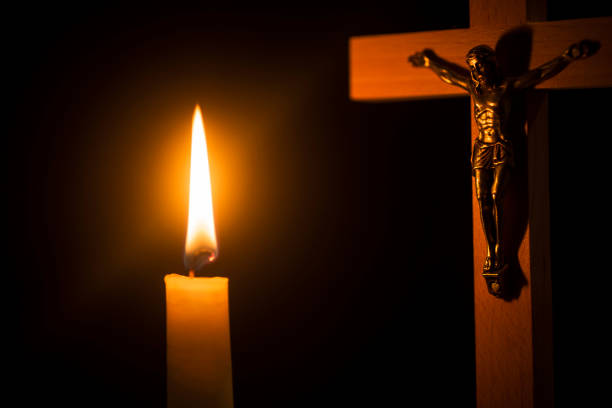 istock Wooden cross with lighted candles in the background 1062835190