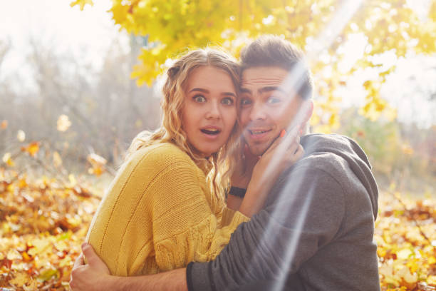 istock Young couple in love in autumn forest 1062837464