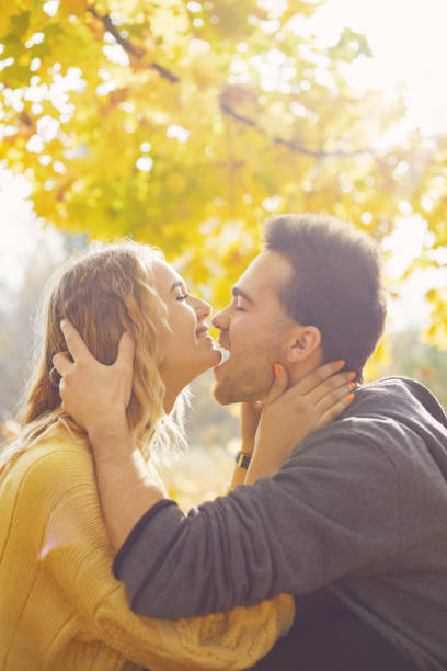 istock Young couple in love in autumn forest 1062837508