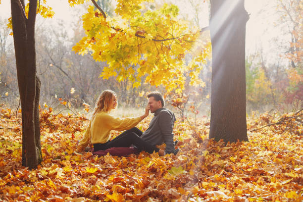 istock Young couple in love in autumn forest 1062838564
