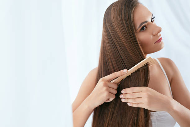 Hair Care. Woman Combing Beautiful Long Hair With Wooden Brush Hair Care. Woman Combing Beautiful Healthy Long Hair With Wooden Brush. High Resolution combing stock pictures, royalty-free photos & images