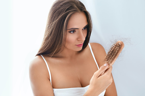 Hair Loss. Upset Woman Holding Brush With Hair, Hair Falling Out. High Resolution