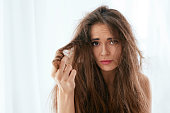 Hair Problem. Woman With Dry And Damaged Long Hair