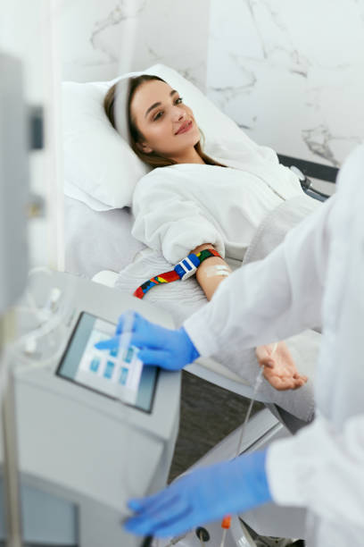 Blood Ozone Therapy. Woman At Blood Transfusion Treatment Blood Ozone Therapy. Woman At Blood Transfusion Treatment Or  Hemodialysis Procedure In Medical Clinic. High Resolution ozone layer photos stock pictures, royalty-free photos & images