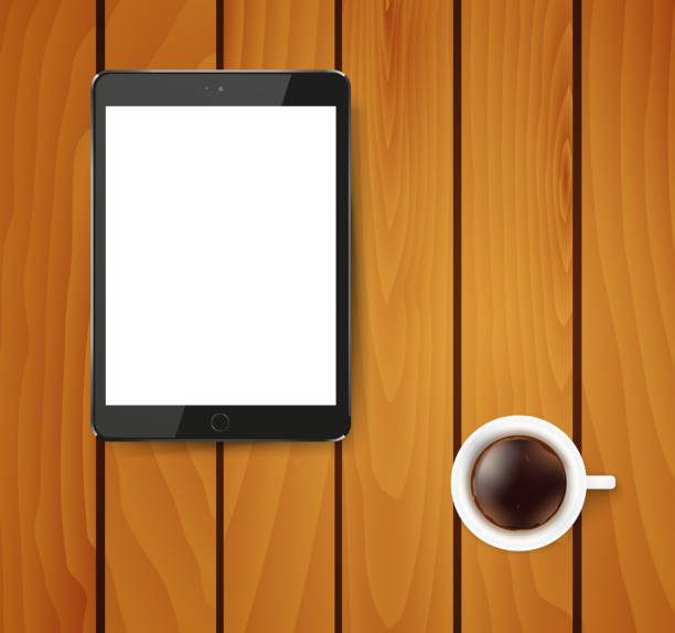 Realistic tablet pc computer with blank screen and cup of coffee.