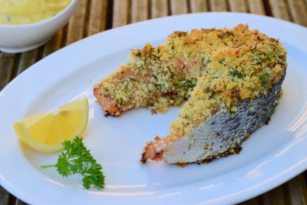 istock Baked salmon with herb crust, served with mashed potato, lemon and parsley 1062847512