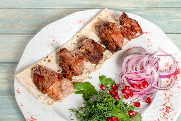 istock Fried meat. Kebab with onion, greens and pomegranate 1062849342