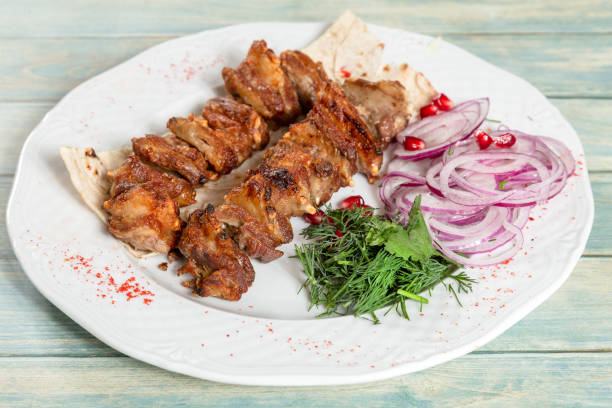 istock Fried meat. Kebab with onion, greens and pomegranate 1062849362