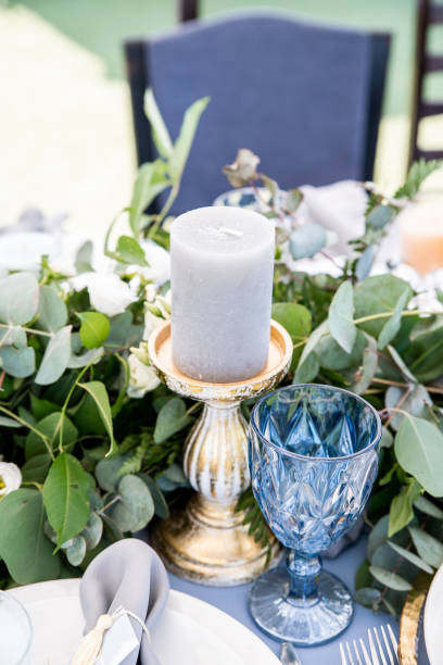 istock Blue wine glasses and grey candle on the decorated table 1062855754