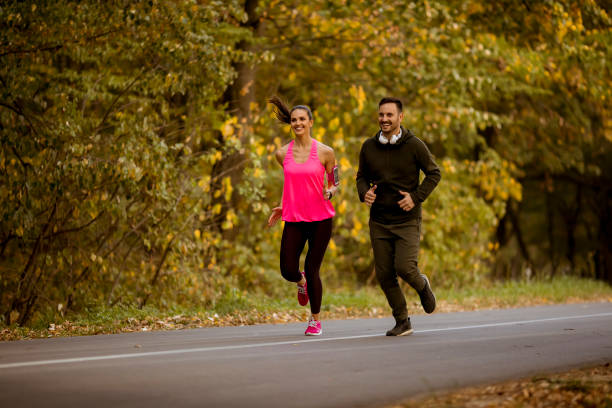 istock Young couple jogging together in park 1062857908