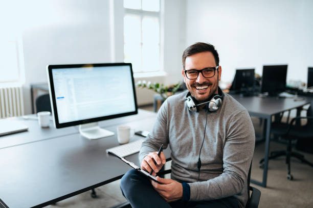 istock Young casual entrepreneur at modern office, looking at camera. 1062867266
