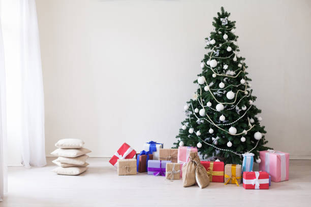 istock Christmas tree with Christmas gifts in white room 1062873098