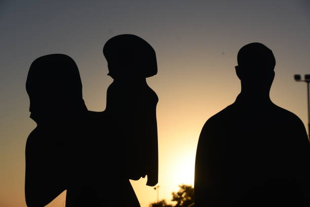 istock Family silhouette at sunset 1062873260