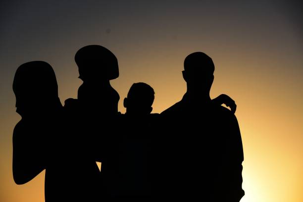 istock Family silhouette at sunset 1062873462