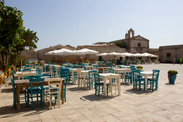 istock Coloured chairs in Marzamemi, Sicily, Italy 1062873508