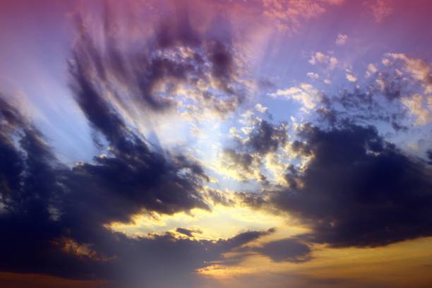 istock marvellous bright with sun rays partially cloudy sky for using in design as background. 1062877470