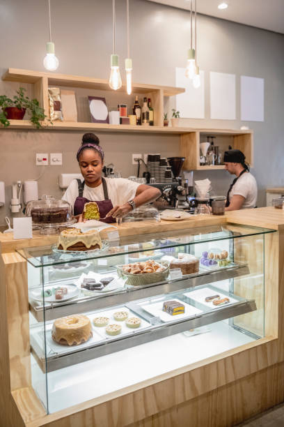 istock Young woman serving cake at cafe counter 1062881050