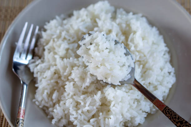 istock closeup eating cooked white rice in spoon from dish 1062883532