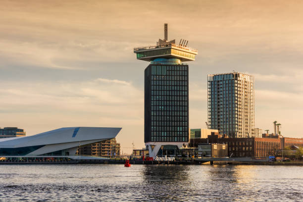 AMSTERDAM, NETHERLANDS - APRIL 13, 2018: The A’dam Tower - a high building in Amsterdam with swing standing, and Eye Film Museum at dawn. AMSTERDAM, NETHERLANDS - APRIL 13, 2018: The A’dam Tower - a high building in Amsterdam with swing standing, and Eye Film Museum at dawn. lookout tower stock pictures, royalty-free photos & images