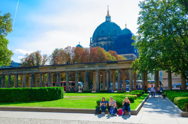 tourists are on territory of famous museum island (on background - berlin cathedral), berlin, germany - berlin cathedral berlin germany museum island sunlight imagens e fotografias de stock