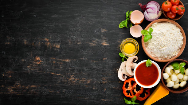 istock Ingredients for making pizza. On a wooden background. Top view. Free space for your text. 1062888164