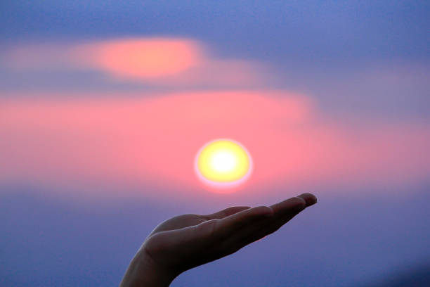 istock Woman hand and sunrise 1062895206