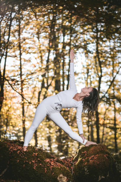 istock Beautiful woman practicing yoga in nature. 1062900566
